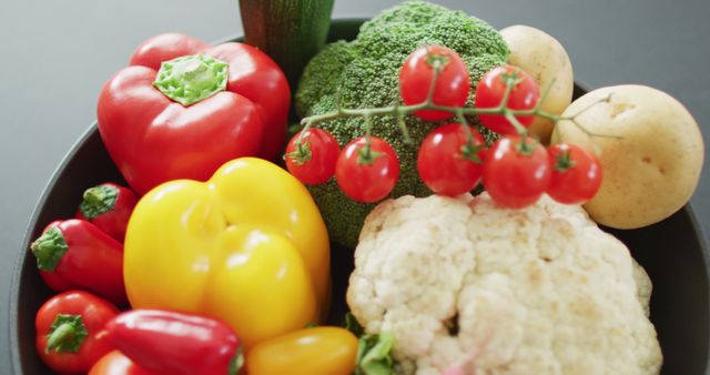 Image of close up of fresh vegetables in pan over grey background. fusion food, fresh vegetables and healthy eating concept.