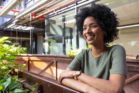 Confident professional woman in modern office with greenery