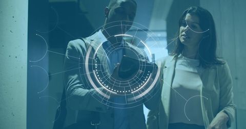 Professionals Analyzing Data on Tablet with Digital Interface