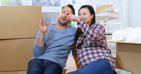 Couple Planning New Home Layout Among Cardboard Boxes - Download Free Stock Images Pikwizard.com
