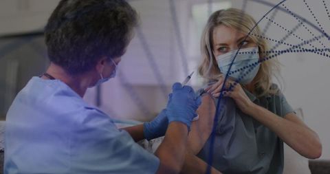 Healthcare professional administers vaccine to female patient in modern clinic