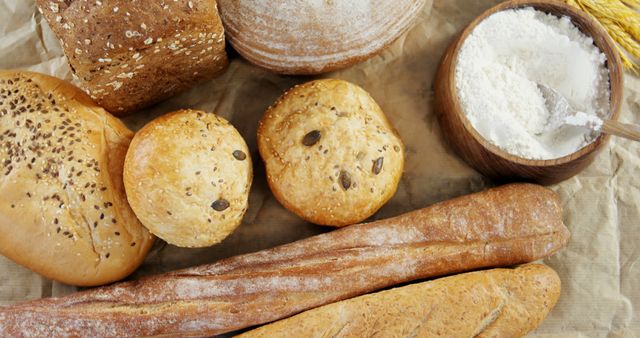 Assorted Fresh Baked Bread with Flour on Parchment Paper - Download Free Stock Images Pikwizard.com