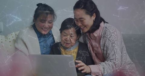Multigenerational family connecting online on couch with laptop and global network overlay