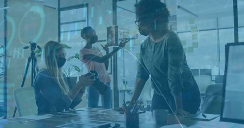 Diverse Team Working on Office Project with Financial Data Overlay