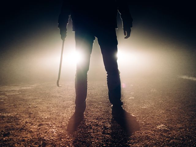 Mysterious figure holding crowbar in dark misty night - Download Free Stock Photos Pikwizard.com
