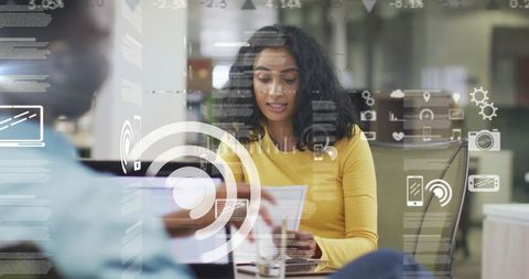 Mixed race business team analyzing financial data innovative office