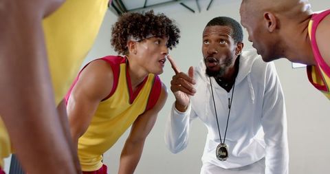 Basketball Coach Guiding Team in Intense Strategy Session