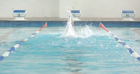 Athlete Swimming Freestyle in Competition Pool Lane