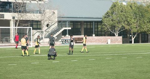 Soccer Match with Players Strategizing on Field