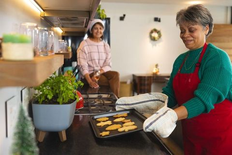 Senior Women Baking Gingerbread Cookies in Holiday Kitchen