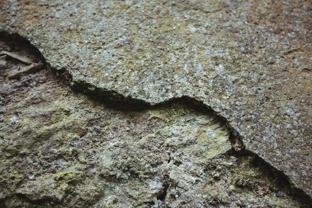 Close-up of weathered stone wall with crack, backgrounds