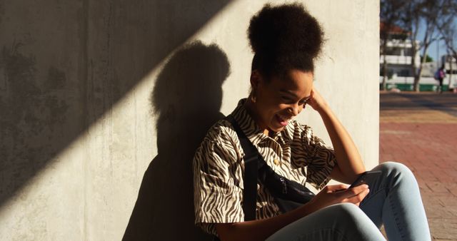 Smiling Woman Leaning Against Wall Using Smartphone Outdoors - Download Free Stock Images Pikwizard.com