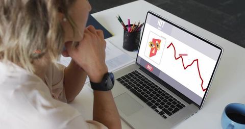 Midadult woman studying nft market on laptop at modern desk focused on crypto trends