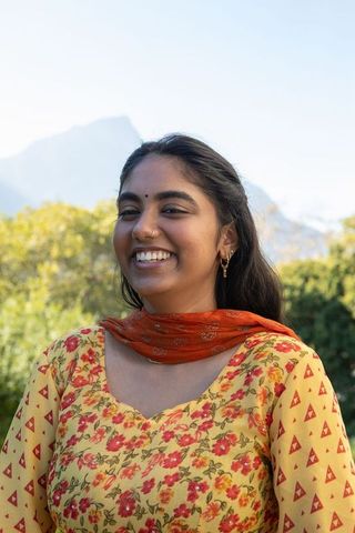 Smiling Indian Woman in Floral Kurta Enjoying Park Views