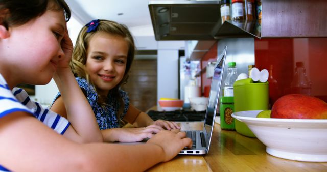 Children Smiling While Using Laptop in Kitchen - Download Free Stock Images Pikwizard.com