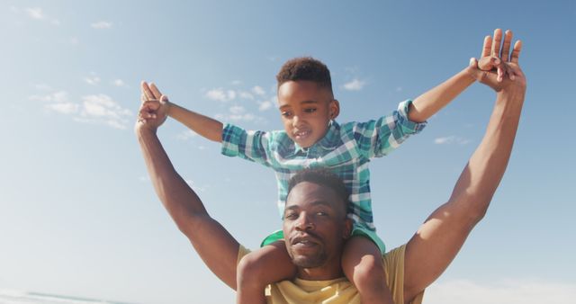 Father Carrying Son on Shoulders at Beach on Sunny Day - Download Free Stock Images Pikwizard.com