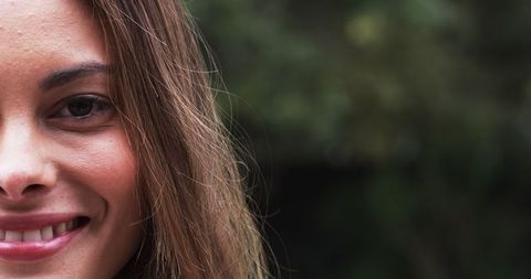 Close-Up Half Face of Woman Smiling Outdoors