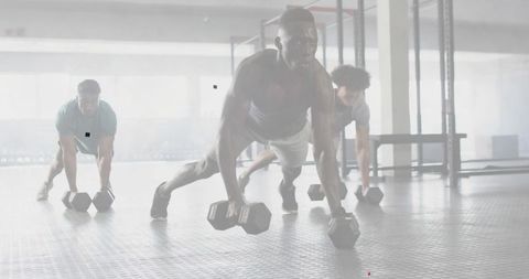 Performing Dumbbell Plank During Group Strength Training for Core Stability and Power