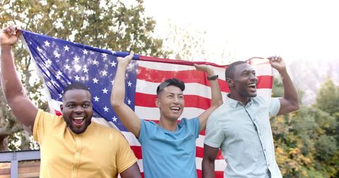 Diverse Friends Celebrate with American Flag Outdoors