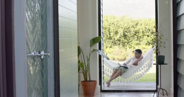 Man Relaxing in Hammock Reading Book in Outdoor Patio - Download Free Stock Images Pikwizard.com