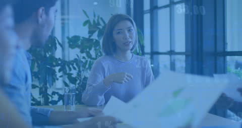 Business Meeting with Financial Data Overlay Illustrating Analysis