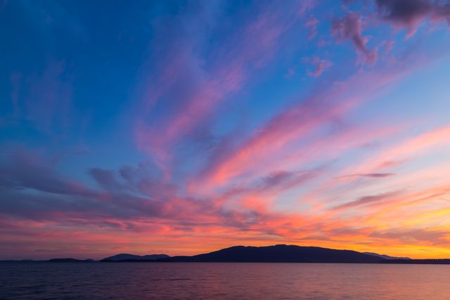 Vibrant Sunset Over Tranquil Ocean and Mountain Skyline - Download Free Stock Photos Pikwizard.com