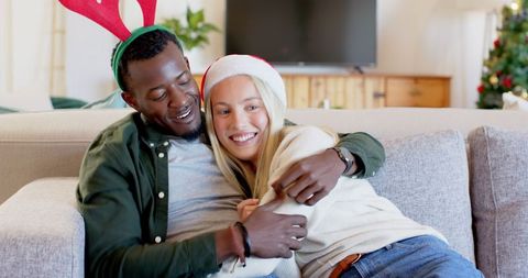 Diverse Couple Embracing Joyful Holiday Moments at Home