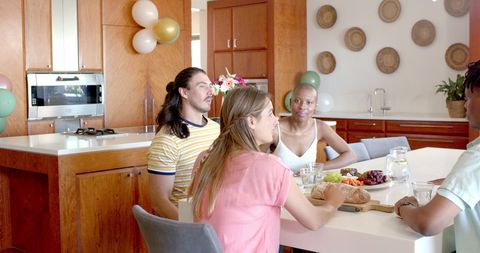 Friends Gather in Modern Kitchen for Casual Celebration