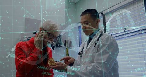 Doctor explaining prosthetic ear to senior with dna overlay