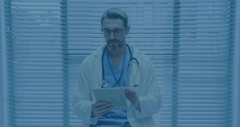 Doctor Using Tablet for Medical Consultation in Modern Clinic