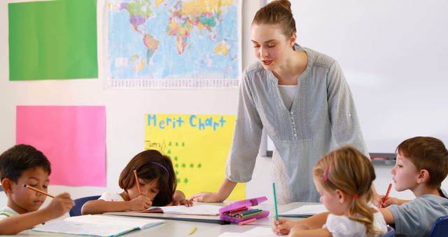 Teacher Helping Young Students in Classroom with Schoolwork - Download Free Stock Images Pikwizard.com