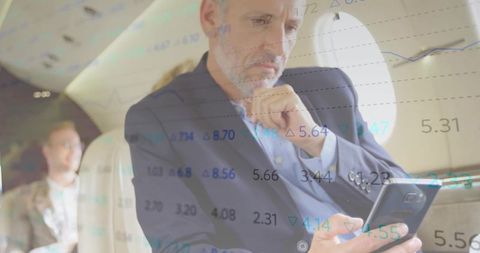 Businessman Analyzing Stock Data on Private Jet
