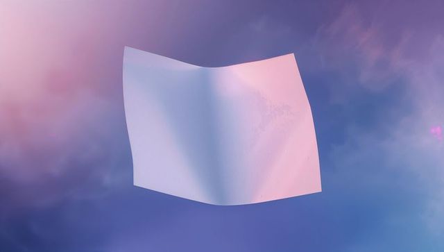 Floating white sheet in dreamlike pastel sky