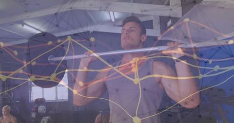 Athletic man lifting barbell for squat in industrial gym with network data overlay