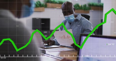 African american businessmen analyzing financial data with graph overlay
