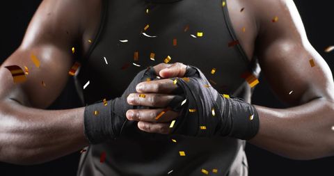 Confetti Celebrating Boxer Clenching Tape-Wrapped Hands
