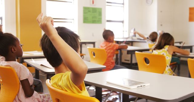 Diverse Classroom with Students Raising Hands for Attention - Download Free Stock Images Pikwizard.com