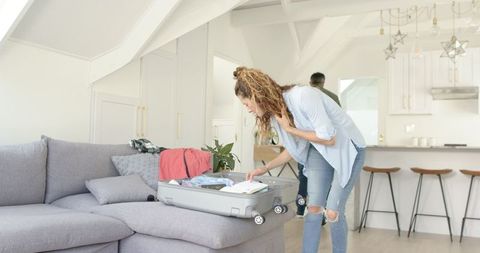 Senior Couple Packing Suitcase at Home for Travel Adventure