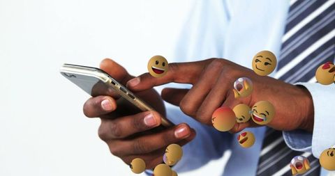 Digital communication with floating emojis around smartphone user