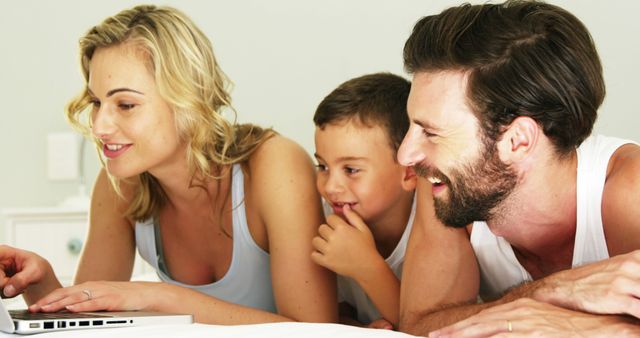 Happy Family Using Laptop Together on Bed - Download Free Stock Images Pikwizard.com