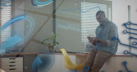 Professional leaning on counter checking smartphone with laptop and augmented hud overlay