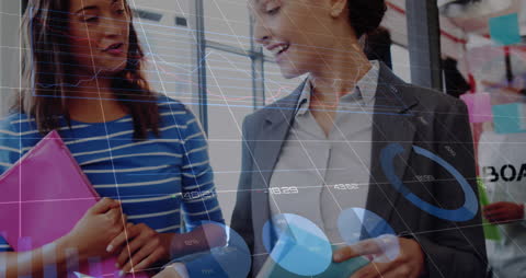 Diverse Businesswomen Analyzing Financial Data with Digital Simulation