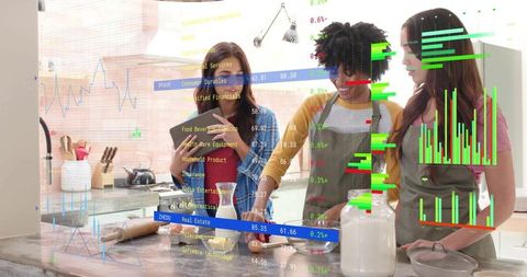 Women collaborating in kitchen using tablet with augmented reality data overlays