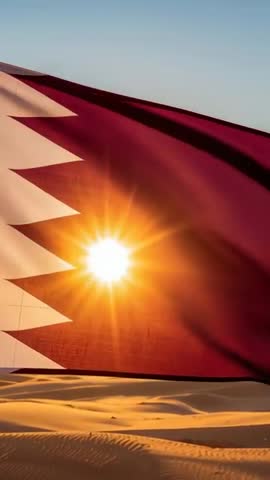 Qatar Flag Waving Over Desert Dunes at Sunset with Sunburst Through Maroon Serrated Banner