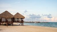 Tropical Beach Huts With Wooden Shaded Cabanas And Tranquil Ocean From 